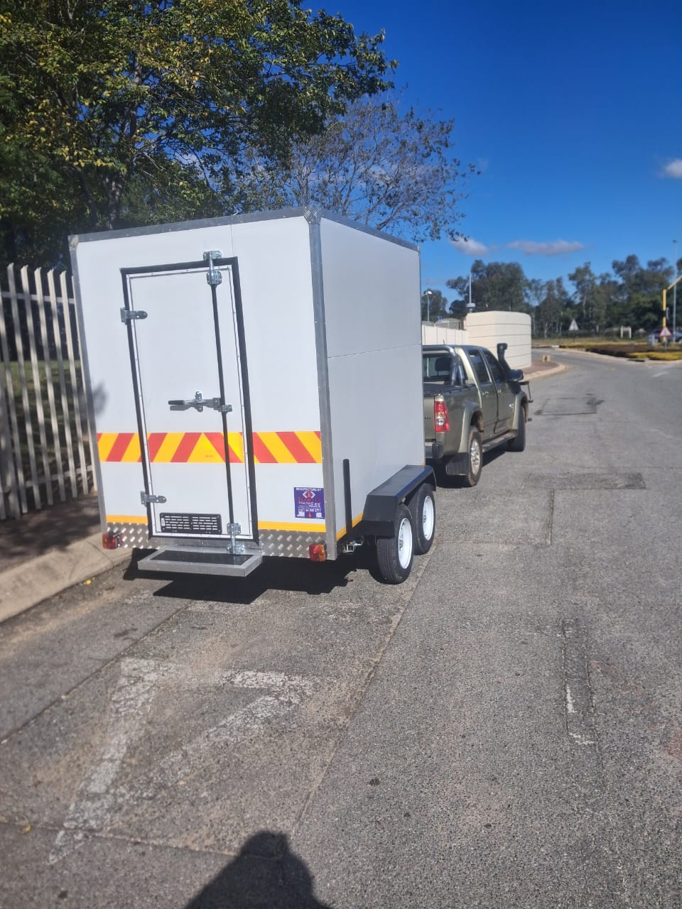 Mobile refrigeration trailer with reflective safety striping