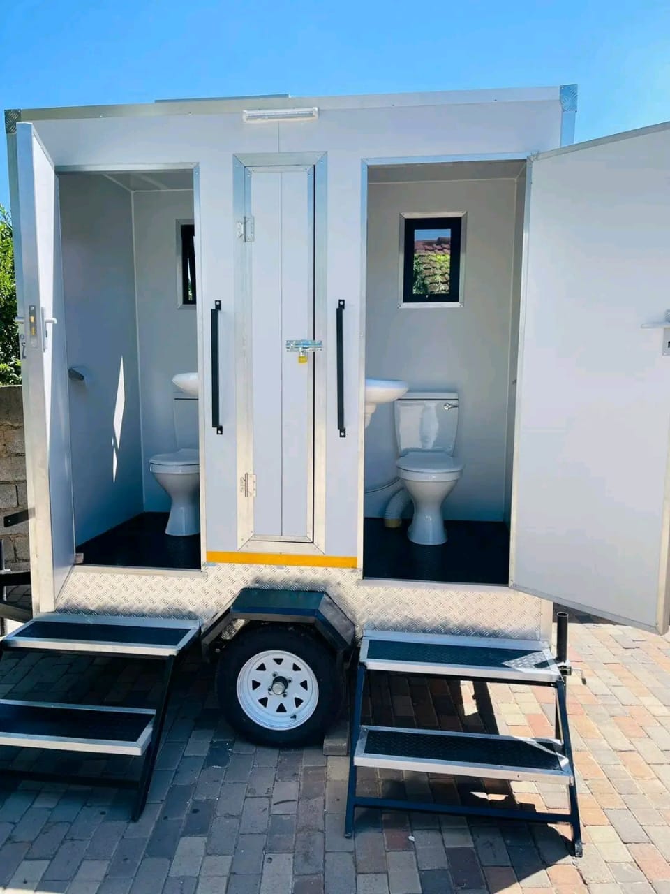 VIP toilet trailer interior — twin units, sky view